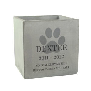 Concrete dog memorial pot with personalised paw print and inscription.