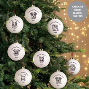 Memorial dog bauble with engraved pet portraits and names, perfect for remembrance.