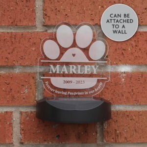 Personalised dog memorial solar light with paw print and name Marley, for outdoor wall display.