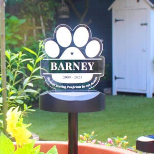 Memorial solar light with paw print design for dog remembrance.