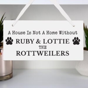 Personalised wooden dog memorial sign with paw prints for pet remembrance.