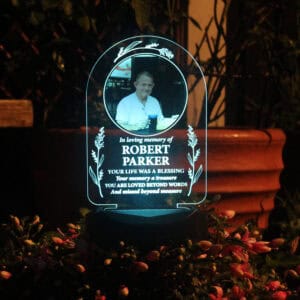 A personalised solar-powered memorial light featuring a photo of Robert Parker, perfect for honourin.