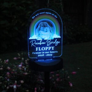 Illuminated Rainbow Bridge dog memorial with personalised message and rainbow design.